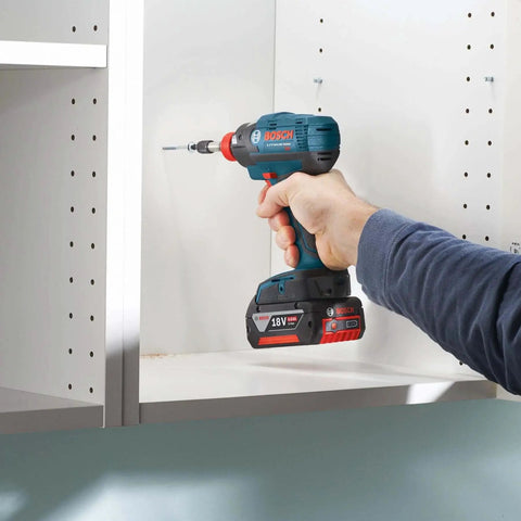 Person using Bosch ITPH235B Impact Tough Phillips Bits Set for Impact Drivers to install screws into a white cabinet.