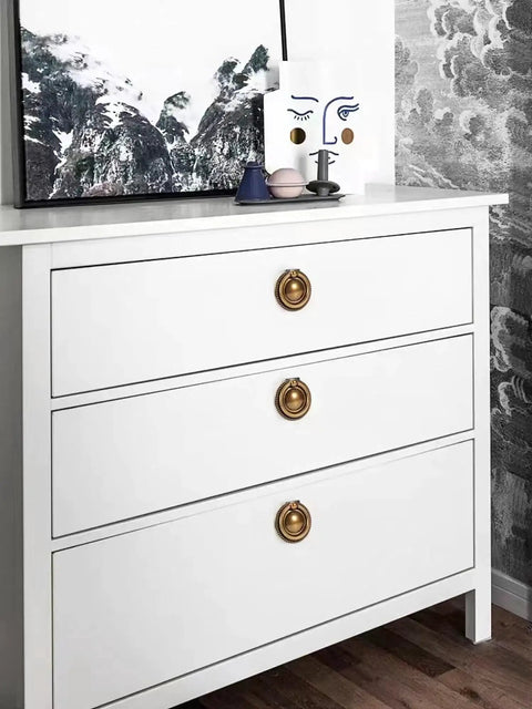 White dresser with 8 Pack 2 Inch Antique Brass Ring Drawer Pulls With Round Plate Base For Cabinets And Cupboards installed.
