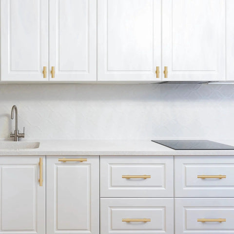 Modern kitchen featuring 6-Pack Solid Brass Cabinet Pulls in Brushed Gold Finish, single hole centers, on white cabinets.