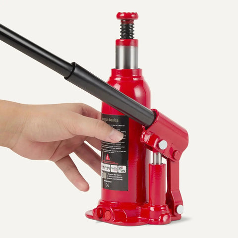 Hydraulic Bottle Jack For Vehicles With 4 Ton Capacity 4000 Kg Slow Release Valve Welded Construction Red Finish shown in hand.