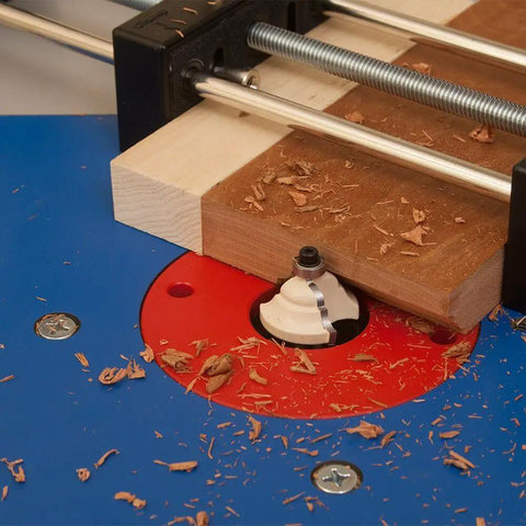 Small Stock Holder For Router Tables That Secures Tiny Wood Pieces And Lets You Feed Wood Safely Keeping Fingers Clear And Delivers Precise Freehand Cuts On Any Router Table securing wood on a router table with shavings visible