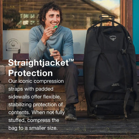 Man sitting with Rugged 100L Wheeled Duffel With Wingjacket Compression And Oversized 110mm Wheels, ideal for long haul trips