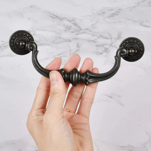 Hand holding 6 Pack Vintage Antique Black Drawer Pulls Handles With 5.5 Inch Hole Center And 6.7 Inch Total Length Made From Zinc Alloy