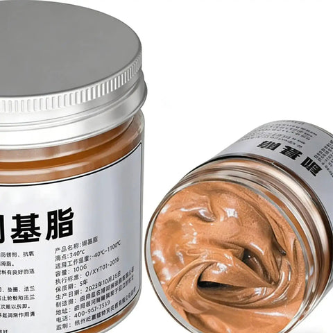 Copper Based Anti Seize Grease 100g Waterproof Long Lasting Paste For Brake Bolts Exhaust Nuts And Threaded Parts Easy Application Pro Grade Lubricant For Mechanics And Technicians shown in a jar with lid off, displaying copper paste inside.