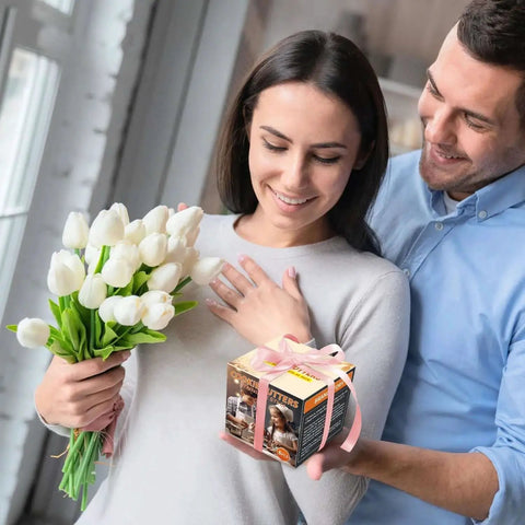 Man gifting woman Five Piece Stainless Steel Biscuit Cutter Set with flowers, smiling indoors.