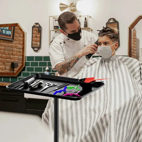 Barber using Adjustable Height Rolling Salon Cart With Tray On Durable Wheels For Tattoo Parlors Spas Dental Clinics And Hair Stylists Built From Corrosion Resistant Iron And Aluminum Anti Tip Design Lockable Casters Stable Mobile Workspace Black