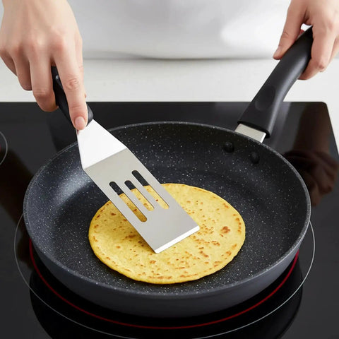 Person using 10 Piece Mini Stainless Steel Spatula Set With Five Solid And Five Slotted Spatulas For Kitchen Cooking And Serving.