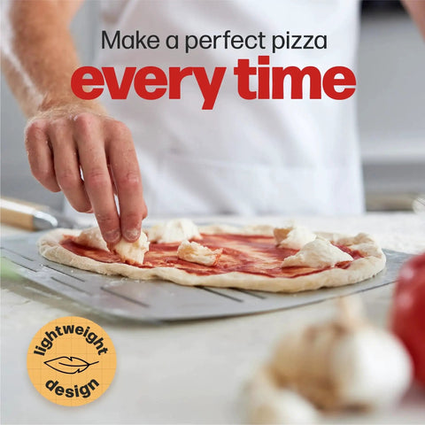 Preparing pizza with Pizza Peel Pro For XL Pizzas Perforated Nonstick Paddle For Crispy Crusts And Quick Venting in kitchen.
