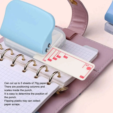 3 Hole Paper Punch Handheld, 5 Sheets Capacity, Metal Body With Slipproof Grip And Plastic Cover in use on B5 paper