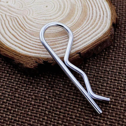 Single M3 60mm cotter pin from 20Pcs M3 60mm Cotter Pins R Clips Hairpin Assortment Kit for trailer hitch lock systems on wood surface.
