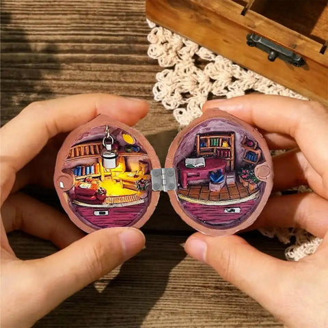 Hands holding a miniature dollhouse scene in a round wooden box, featuring tiny furniture and decor, showcasing 100 Pcs Tiny Dollhouse Hinges 0.7 x 0.51 Inches 180 Degree Miniature Metal Hinges With 400 Screws Silver Durable Iron Hardware for Wooden Boxes Cabinets Dollhouse Furniture Craft.
