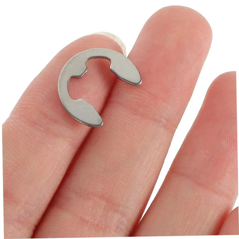 Circlip And Split Washer 300 Piece Set Stainless Steel 304 E Type Retaining Rings Transparent Storage Case For Quick Access Pro Grade Rust Resistant Fastener Kit For Industrial Projects close-up of single E-type circlip on fingers.