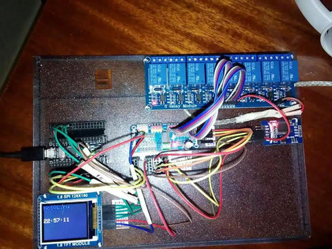 PCA9685 16 Channel 12 Bit PWM Servo Driver Board with I2C interface connected to microcontroller and display, on a wooden surface