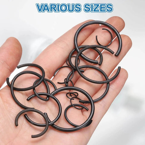 Hand holding 40Pcs Round Wire C Clips Set For 28mm Holes Heavy Duty Internal Snap Rings Retaining Rings Built From 70Mn Carbon Steel