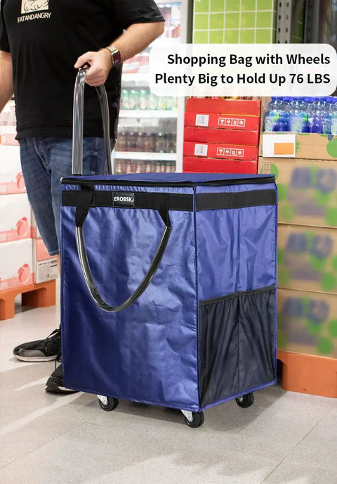 Navy medium reusable grocery bag on wheels with 70L foldable rolling tote carries up to 66 lbs, side view in a store setting.