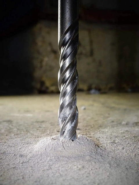 SDS Plus 5 by 32 Inch by 6 Inch Carbide Tipped Rotary Hammer Drill Bit drilling into concrete, close-up view