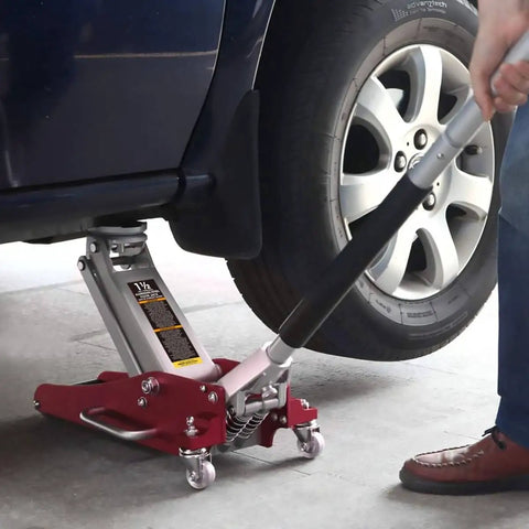 1.5 Ton Aluminum And Steel Hydraulic Floor Jack With Dual Piston Quick Lift Pump Low Profile Racing Car Jack For Vehicles Lightweight Yet Beefy 3000 Lb Capacity Red Finish lifting a car's tire