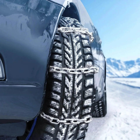 Car tire with zinc-plated chains in snow, showcasing Grade 30 Chain Quarter Inch By 100 Feet Zinc Plated Proof Coil Chain.