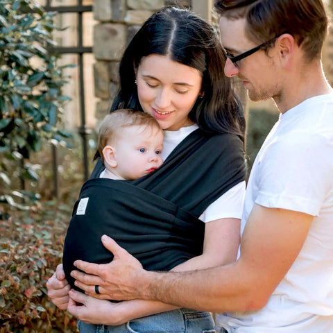 Parents using D Lite Baby Wrap Carrier Ring Sling For Newborn To Toddler With Easy Adjust Ergonomic Comfort And Breathable Fabric outdoors