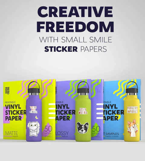 Colorful bottles and boxes of printable vinyl sticker paper featuring cartoon designs and text 'Creative Freedom'