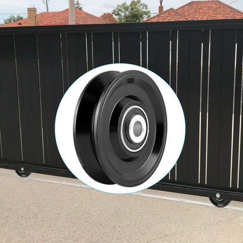 V Groove Wheel Caster for Inverted V Track with double bearings, steel AISI 1045, shown in front of a black gate.