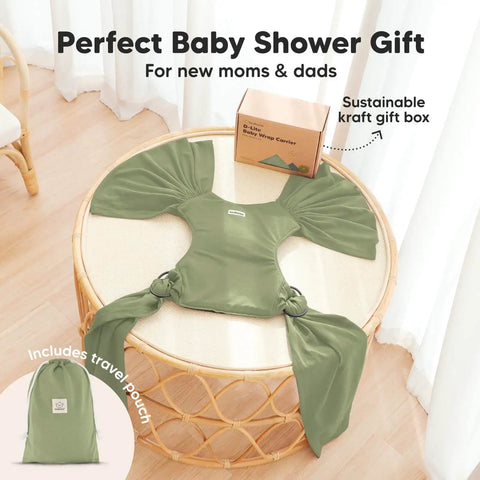 D Lite Baby Wrap Carrier Ring Sling in green on a table with gift box and travel pouch, showcasing ergonomic comfort and breathable fabric.