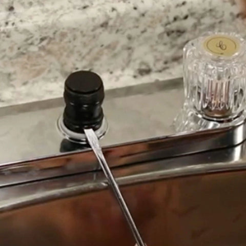 Danco 80360 waterproof faucet grease installed on chrome faucet with black plastic cap and clear knob