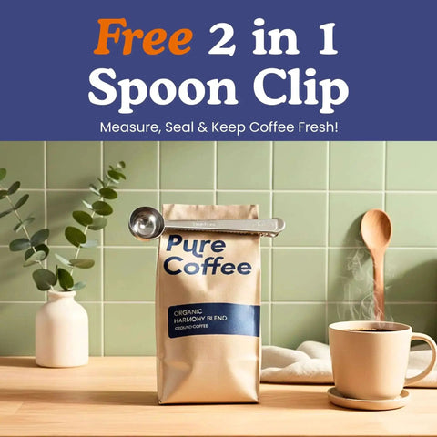Coffee bag with Free 2 in 1 Spoon Clip against green tile wall, wooden spoon and cup, greenery in vase