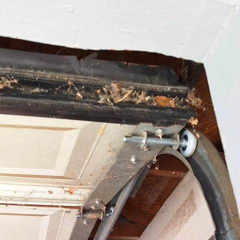 Close-up of 15 Pack 2 Inch Nylon Garage Door Rollers With Sealed 6200ZZ Bearings installed on a residential garage door track.