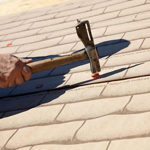 Installation of 12 Gauge 1 Inch Plastic Cap Roofing Nail With Diamond Point Ring Shank Electrogalvanized Steel on roofing material.