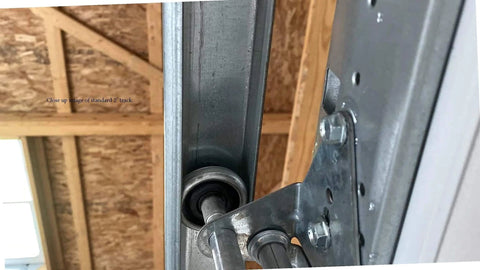 Close-up of a heavy duty vertical track rail for 8 foot garage doors, made in USA from durable US steel, installed view.