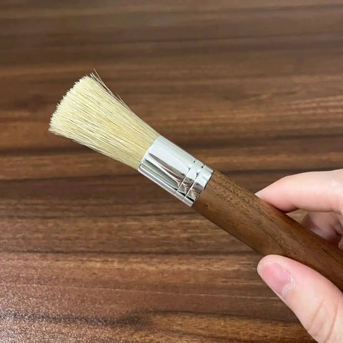 Grinder Cleaning Brush Set With Walnut Wood Handle And Natural Bristles For Espresso Machines And Home Baristas shown in hand