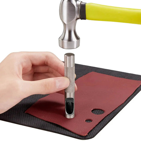 Using 12 Piece Hollow Leather Punch Set Made Of Steel on leather material with a hammer for precise crafting.
