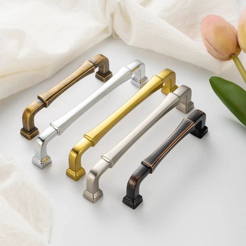 Variety of metal cabinet pulls with different finishes on display, including oil rubbed bronze. Kitchen and drawer hardware collection.