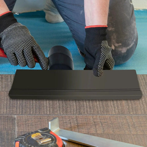 Universal Tapping Block For Vinyl Plank Flooring 3 Edges Notched Tongue Groove, shown in use by installer on wood floor