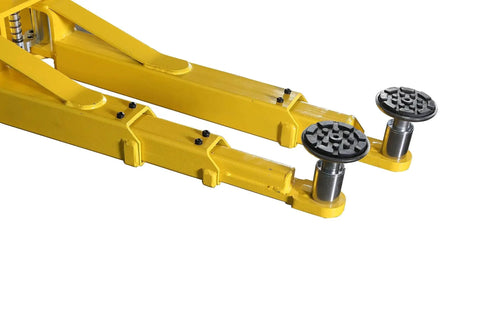 Side view of yellow steel two-post floor-plate car lift arms with adjustable wheel pads