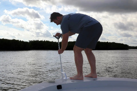 Man using Heavy-Duty Bow Mount Anchor For Shallow Water Deployment, Marine-Grade Aluminum Deck Mount With Black Powder Coat on boat