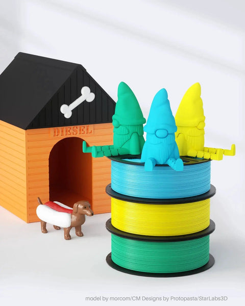 Colorful gnome figures sitting on stacked black spools beside a model dog house with a small toy dog nearby.