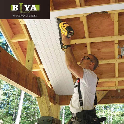 Person using a nail gun on wooden beams under construction with a visible BIYA logo in the top left corner.
