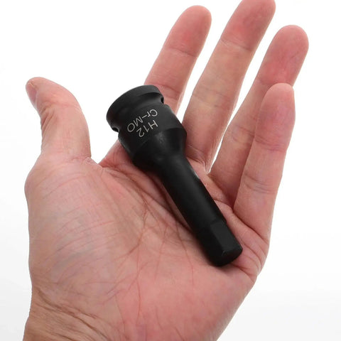 Hex impact socket adapter with extended sleeve, black metal, held in hand