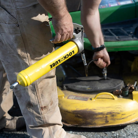 LockNLube premium pistol-grip grease gun with yellow body, 20-inch hose and inline swivel (side view)