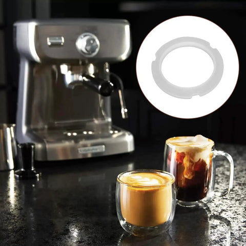 Clear Silicone Sealing Gasket For Coffee Machines 76X57X7MM OE 6V0945246 shown beside an espresso machine