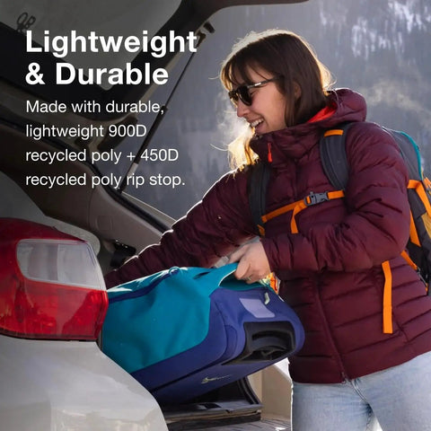 Woman loading Daylite 40L Wheeled Carry On Collapsible Duffel Bag With Backpack Carry in car trunk, highlighting lightweight and durability features.