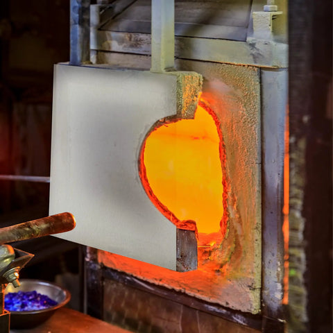 White ceramic fiber kiln paper sheet 11 x 12 in for high-temperature insulation inside a glowing kiln.
