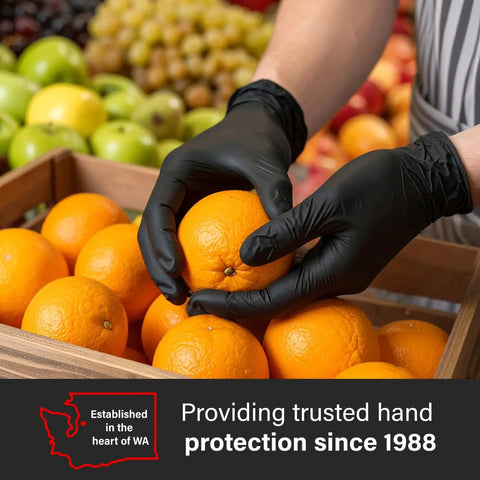 Person wearing Black Nitrile Gloves 5 Mil For Cooking Food Prep Disposable Large Box Of 100 holding oranges.