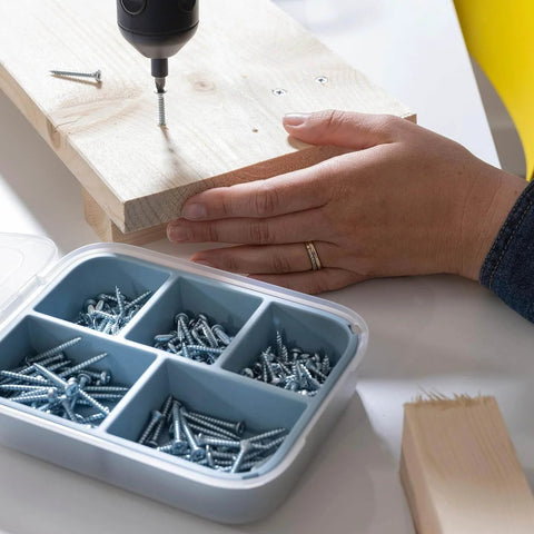 Person using 200 Piece Wood Screw Set With Galvanized Steel Fasteners In Three Lengths 4x16mm 4x25mm And 4x35mm, showing screws and toolbox.