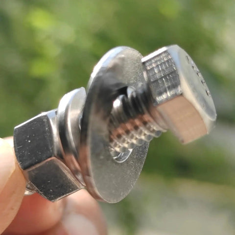 Close-up of 8 Sets 3/8-16 X 1-1/4 Stainless Steel Hex Head Screws Kit With Nuts Flat And Lock Washers, showcasing threading detail.