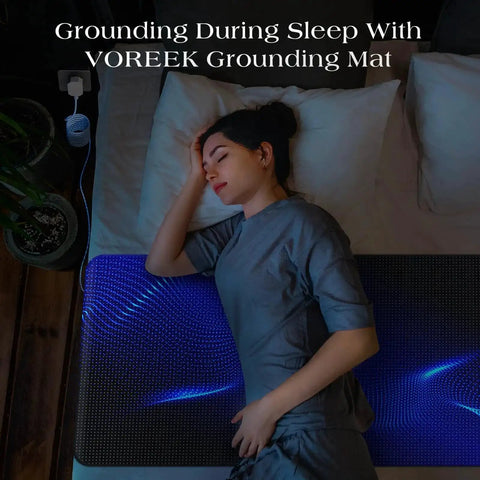 Woman using Grounding Mat For Bed With Earth Connected Mattress Cover And Grounded Kit Cord Included California King Size Sleep Health Upgrade For Natural Energy And Better Rest At Home in dimly lit bedroom.
