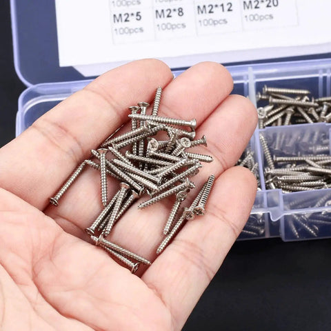 Hand holding M2 Flat Head Self Tapping Screws Set For Woodworking, Nickel Plated Carbon Steel, Cross Drive, in assorted sizes.
