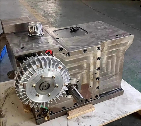 Hollow-shaft electromagnetic powder brake mounted on a metal housing; front driveshaft visible.